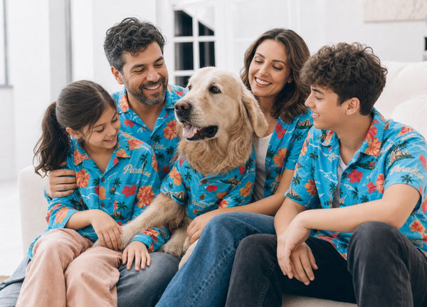 Husband and wife seated together with two dogs, warm editorial family portrait